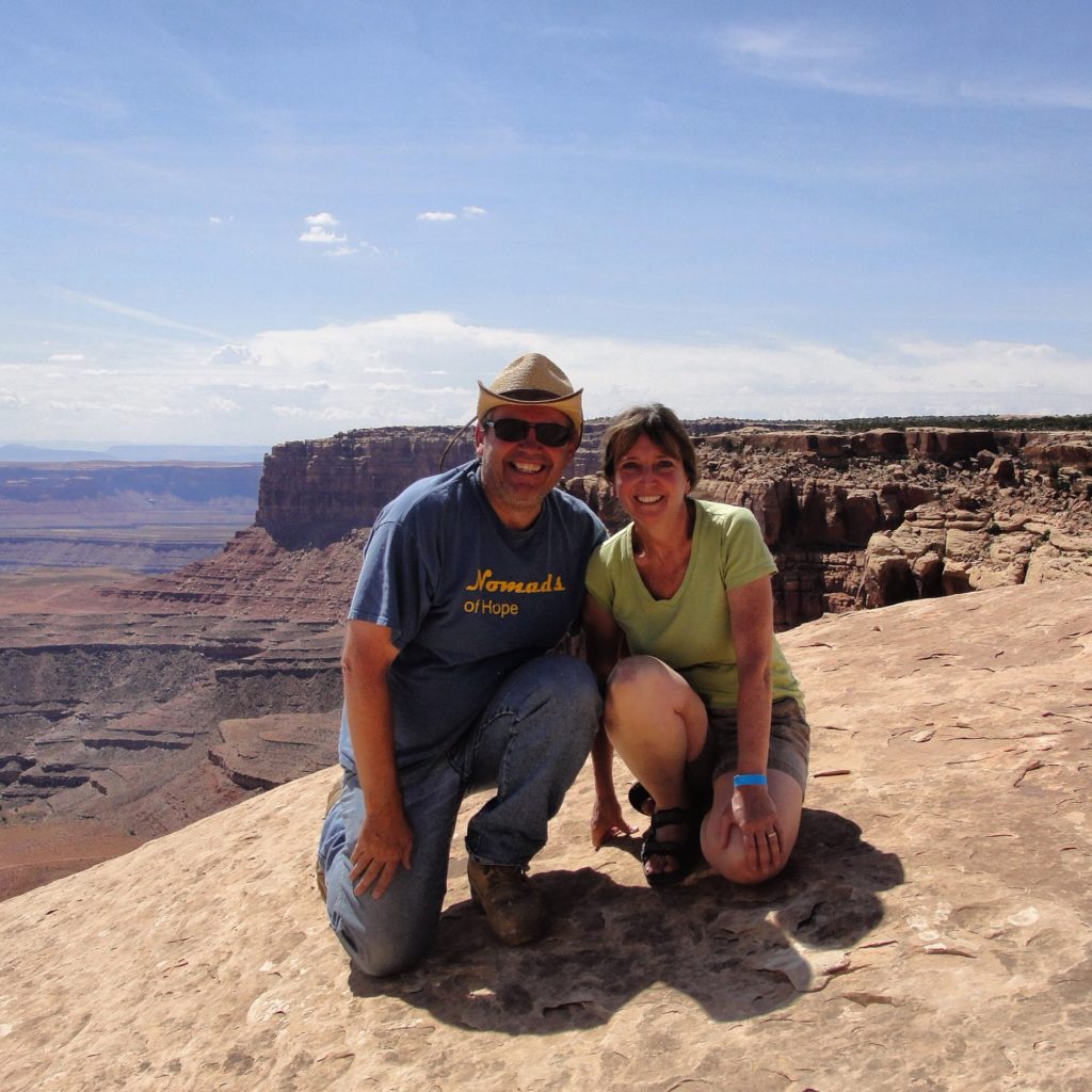 Rod and Linda Shorette kneeling at Muley Point, Utah